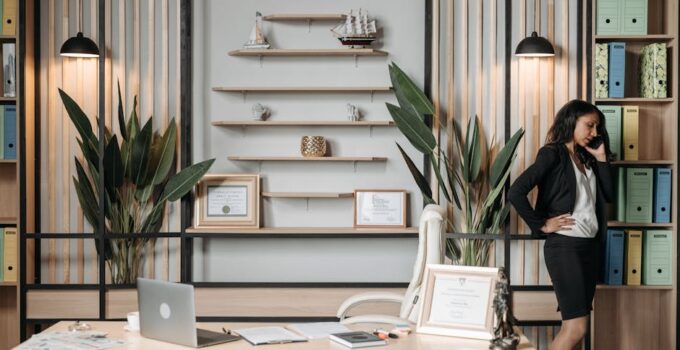 Businesswoman on phone in stylish office, showcasing professionalism and modern work environment.